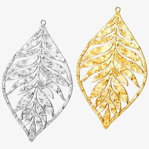 Close-up of hollow leaf pendants in silver and gold finish with hammered metal texture