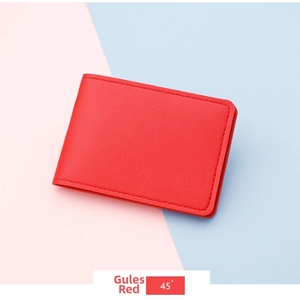 Detail of red lychee grain leather card holder with precise stitching on split background