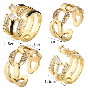 Detailed view of four gold-plated rings with colorful zircons and enamel details