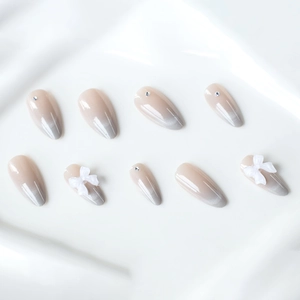 Nude grey ombre cat eye press-on nails with 3D white bows and silver rhinestones