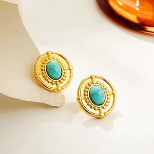 Close-up of vintage oval turquoise stud earrings with polished 18K gold-plated base