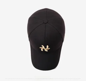 Top view of a black cotton baseball cap showing structured crown and gold leaf embroidery