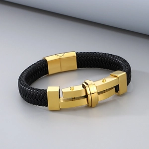 Close-up of black braided leather bracelet with golden stainless steel cross buckle