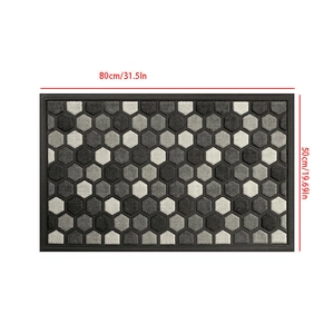 Close-up of geometric honeycomb pattern door mat with non-slip rubber border and size markings