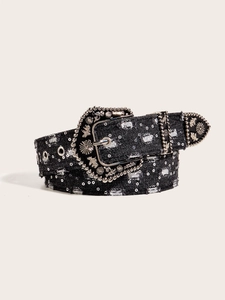 Detail of black denim belt with ornate silver buckle, rivets, and sequin decorations