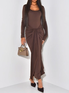 Elegant brown long sleeve dress with waist knot detail and side slit shown in a studio