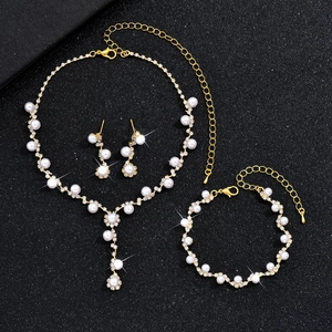 Detailed view of elegant pearl necklace, bracelet and earrings set with gold finish