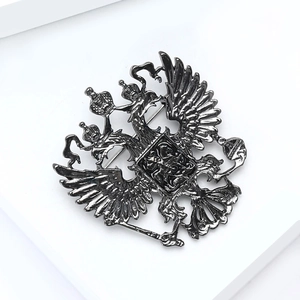 Detailed relief of vintage dark silver double-headed eagle brooch with crown and scepter