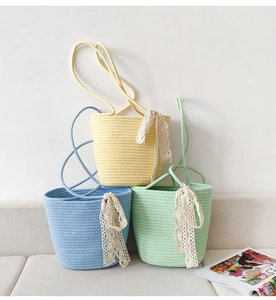 Detailed knit texture of shoulder bags in yellow, blue, and green with lace ribbons