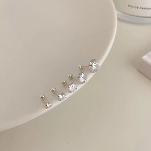 Detail of five assorted sizes of cubic zirconia stud earrings with screw-back design