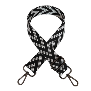 Detail of adjustable black and white V-pattern woven strap with metal swivel hooks