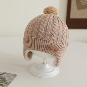 Detail of baby knitted hat with thick fleece lining and cozy cable knit pattern