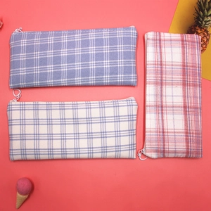 Detail of plaid canvas pencil cases with heart shaped metal zippers and vibrant colors