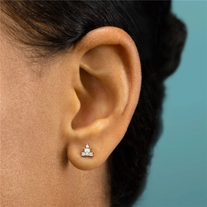 Close-up of S925 silver gold-plated geometric stud earring with sparkling stones