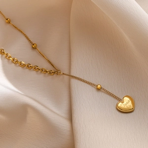 18K gold-plated stainless steel heart necklace with Forever engraving on satin background