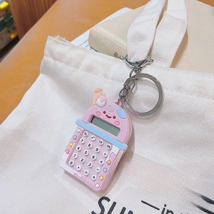 Pink milk tea cup mini calculator keychain shown hanging on a white canvas bag