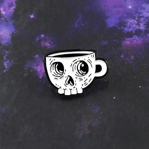 Creative coffee cup and skull enamel pin with classic black and white contrast design