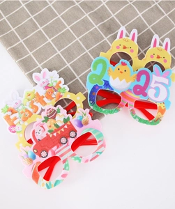 Close-up of Easter party glasses with 2025 rabbit, chick and egg festive motifs