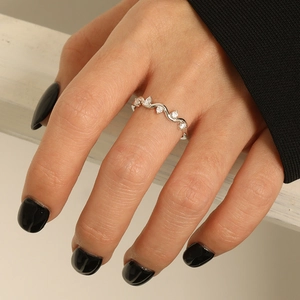Minimalist S925 sterling silver wave ring with zircon stones on a model's hand