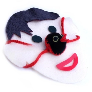 Detail of a handmade knitted animal nose warmer featuring a red beak and creative craftwork