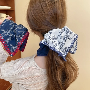 Detail of floral fabric scrunchies with vintage patterns and decorative contrast stitching