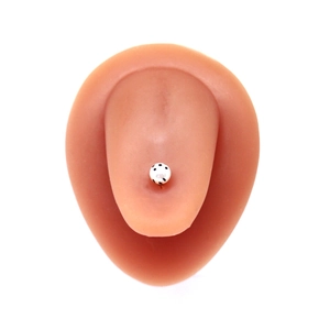Polka dot strawberry tongue ring on silicone model with gold metal barbell post