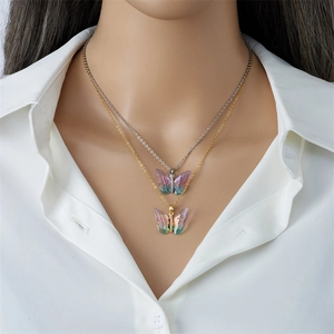 Layered gold and silver butterfly pendant necklace in iridescent purple on model