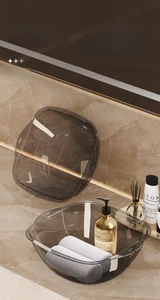 Close-up of durable transparent grey square washbasin with handles on marble vanity