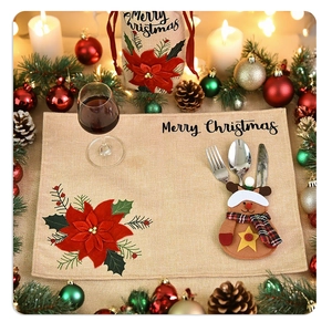 Christmas table set with linen placemat, reindeer cutlery holder and floral wine cover