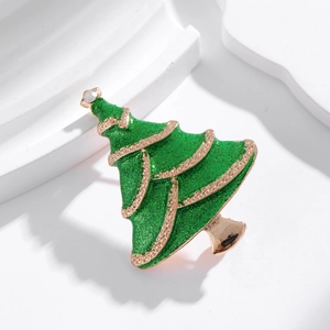 Sparkling green Christmas tree brooch with golden trim and rhinestone on a white background