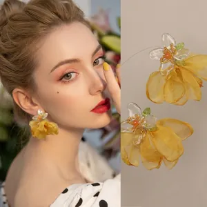 Details von gelben Organza-Blütenohrringen mit transparenten Blütenblättern