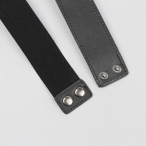 Detail of black elastic belt showing matte leather ends and silver snap button fasteners