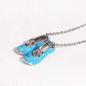Detailed macro view of dual light blue ballet slipper pendants with silver chain