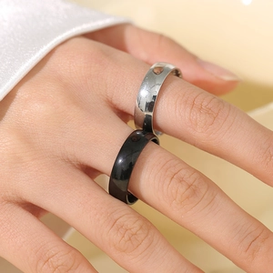 Minimalist stainless steel ring set with black enamel and polished silver finish on finger