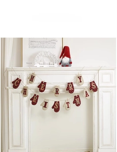 Detail of Merry Christmas bunting with red plaid mittens and wooden clips on fireplace