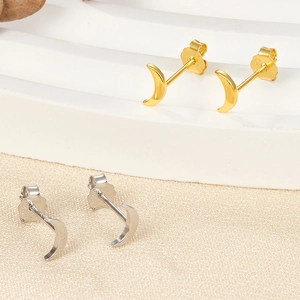 Close-up of crescent moon earrings in gold and silver with S925 sterling silver hallmarks