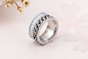 Macro shot of silver rotatable chain ring with rectangular cubic zirconia inlays