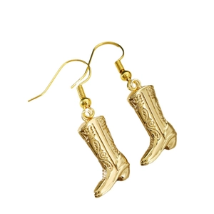 Fashionable golden cowboy boot earrings with vintage embossed texture on white background