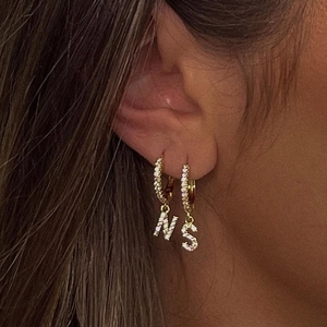 Gold letter earrings with N and S pendants paved in sparkling zircon stones for women