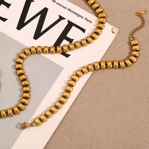 Minimalist 18K gold plated stainless steel linkage necklace on a fashion magazine