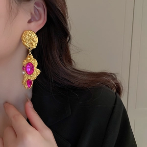 Baroque floral earrings with pink crystals and pearl on model in black suit