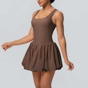 Detail shot of coffee brown athletic mini dress with pleated bubble hem and open back style
