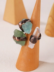 Detail of vintage punk rings featuring raw crystals on bronze plated metal bands