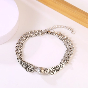 Double-layered silver wing bracelet with a detailed central sphere and cuban chain design