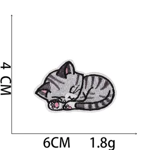 Macro detail of cartoon cat embroidery patch showing 4x6cm dimensions and weight