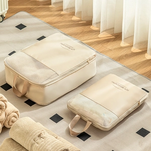 Beige travel compression organizers with mesh windows and durable handles in two sizes