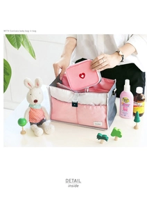 Detail of multi-compartment travel medical organizer with a small heart emergency pouch