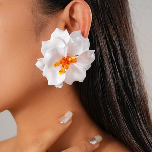 Exaggerated white acrylic flower earrings with orange beaded center for vacation style