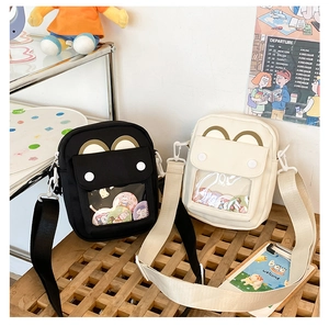 Detailed view of ITA bag with transparent PVC window and animal ear design on canvas fabric