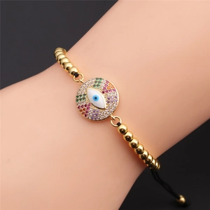 Detail of adjustable evil eye bracelet with gold beads and colorful zircon accents